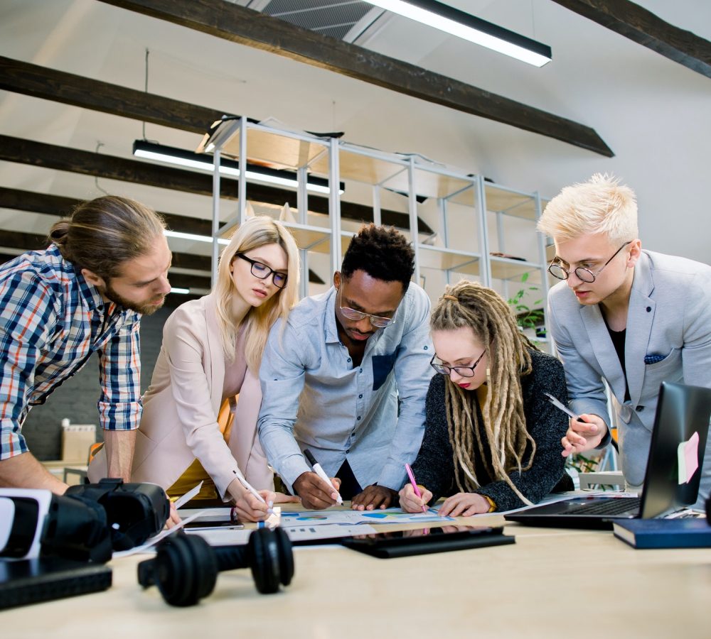 creative-multiethnic-team-of-five-skilled-young-colleagues-working-with-data-and-marketing-charts-in.jpg